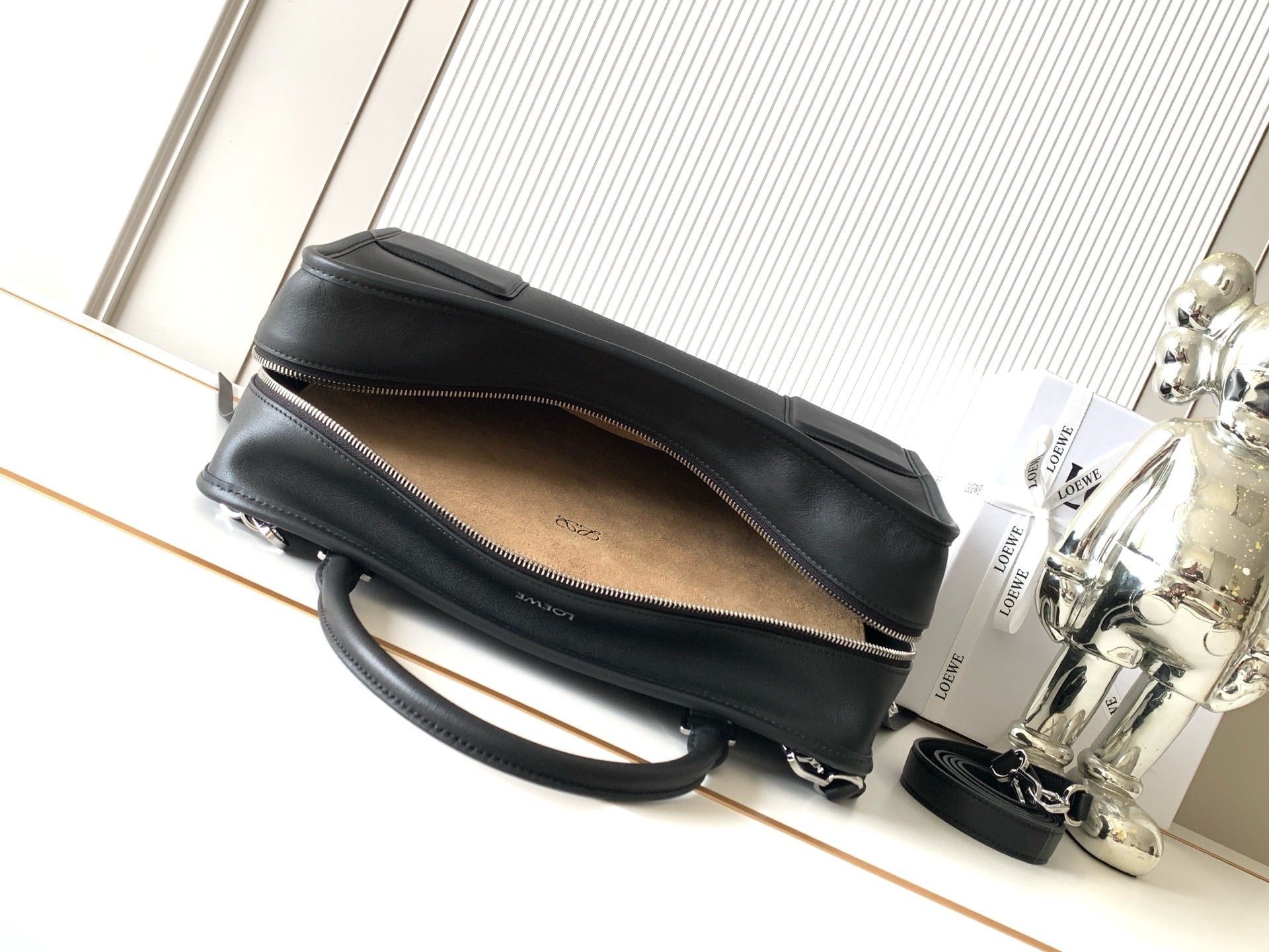 Loewe black leather bag with open top and tan lining