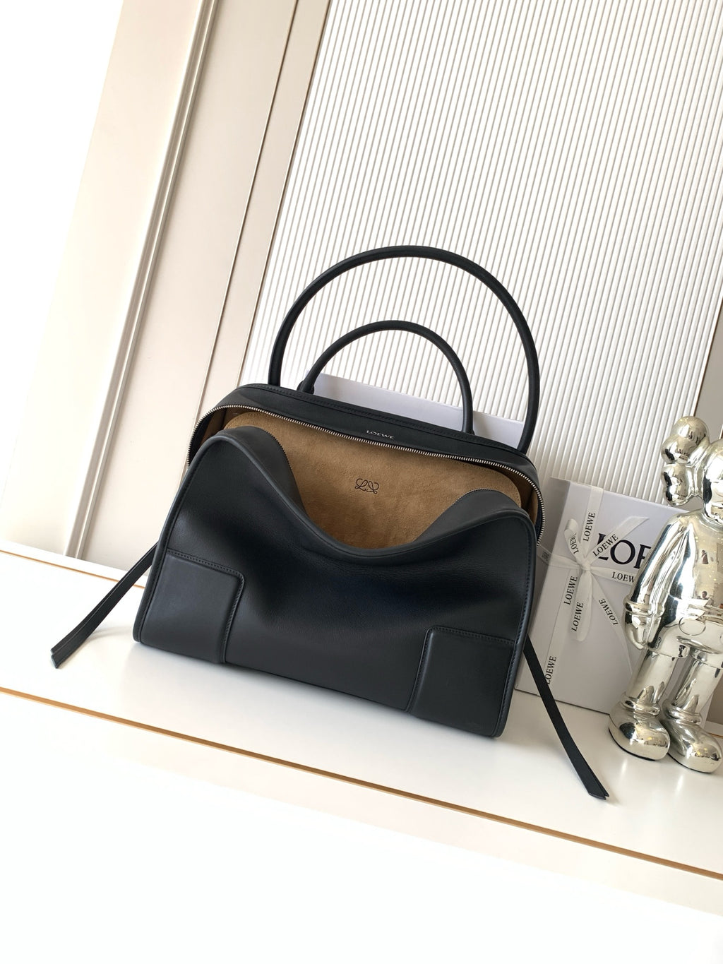 Loewe black leather top-handle bag with rounded silhouette and two handles