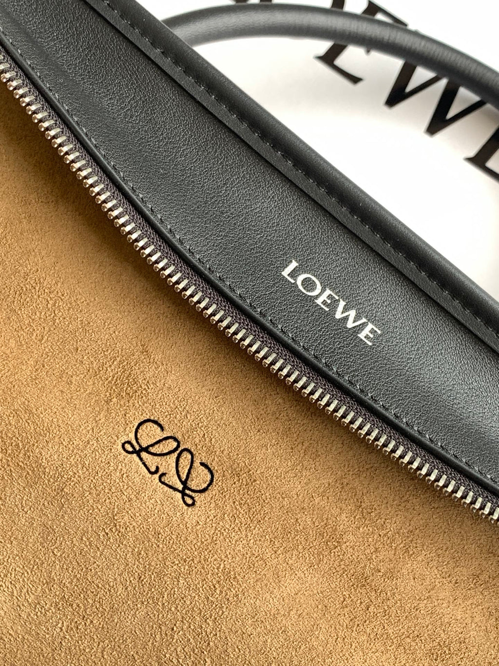 Black leather bag interior zipper track with Loewe label