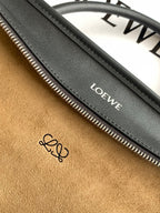 Black leather bag interior zipper track with Loewe label