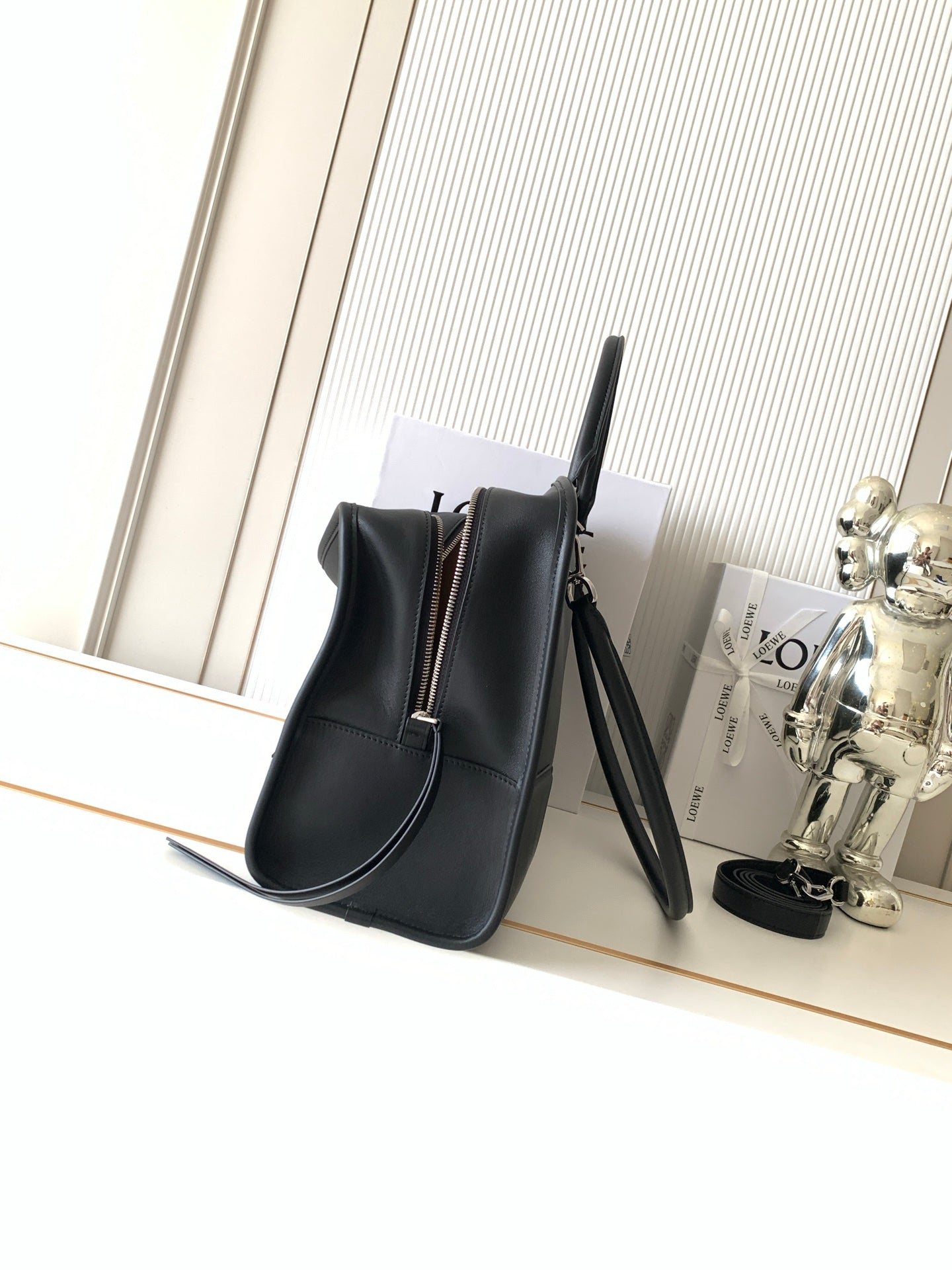 Loewe dark leather bucket-style bag with short handles and long crossbody strap