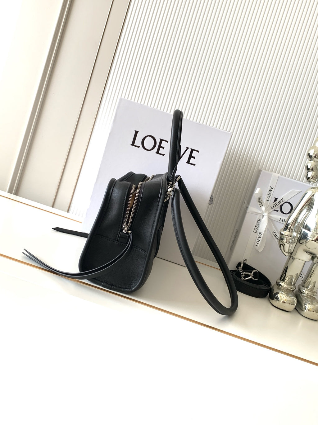 Black Loewe-branded crossbody bag with long strap and side zip detail