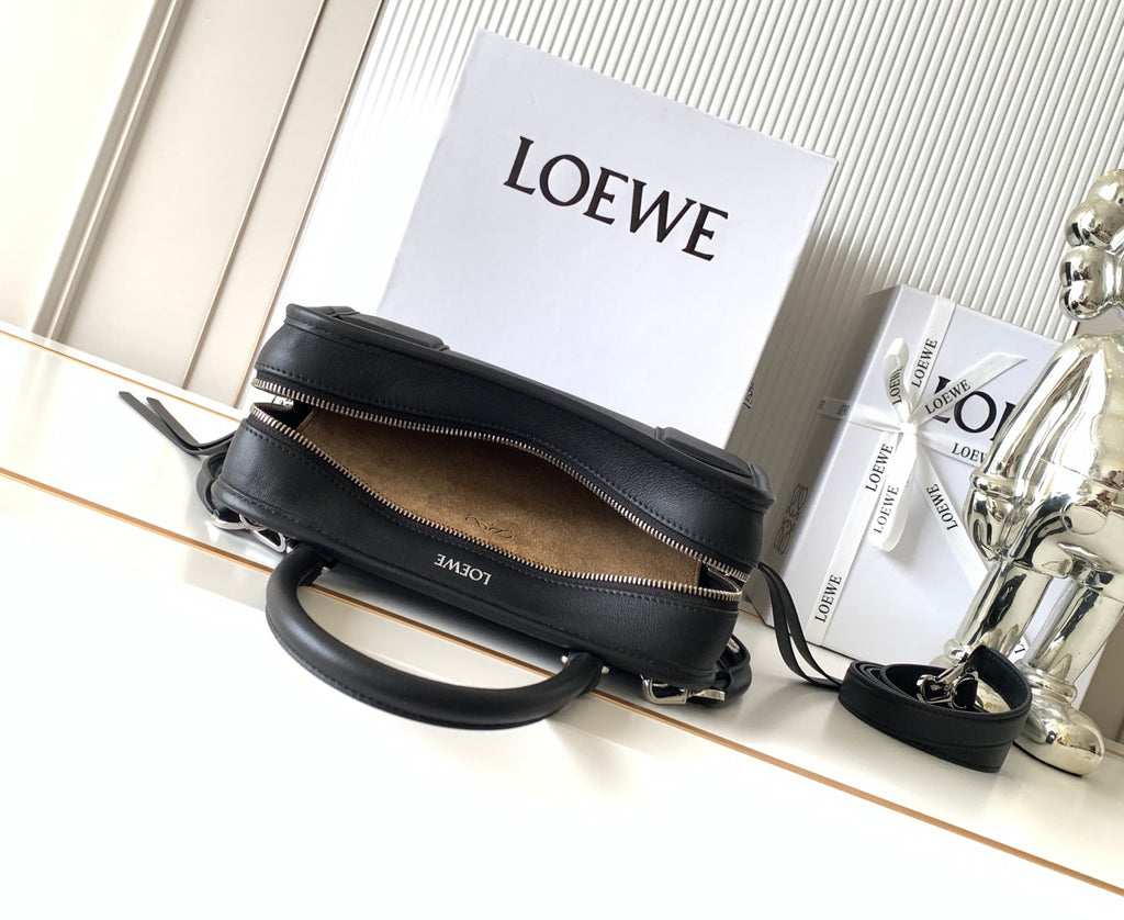 Black Loewe-branded zip bag with top zipper and crossbody strap