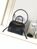 Black Loewe-branded top-handle bag with dual handles and gold-tone zipper