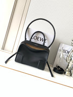 Black Loewe-branded top-handle bag with dual handles and gold-tone zipper