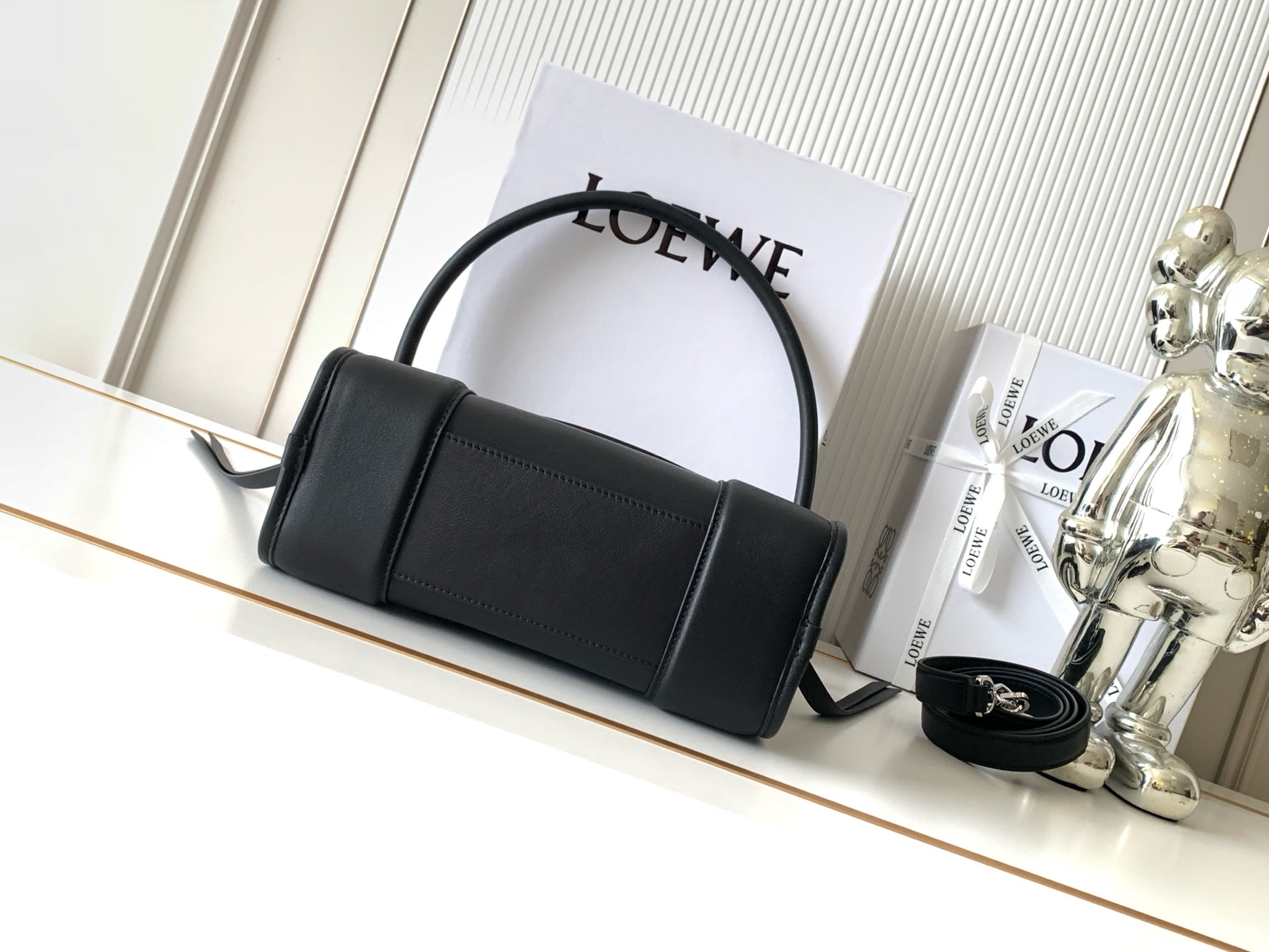 Black Loewe-branded shoulder bag with top handle and structured rectangular body