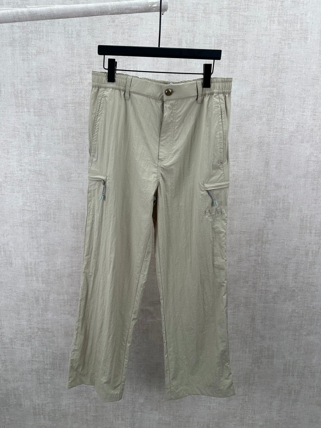 Light olive cargo pants with drawstring waist and button closure