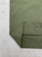 Olive green Louis Vuitton pants fabric close-up at folded hem and side seam