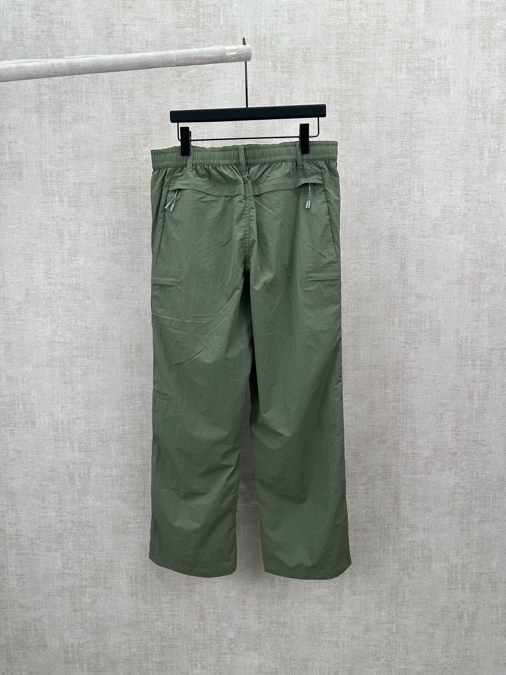 Olive green Louis Vuitton pants, back view with two rear pockets and belt loops