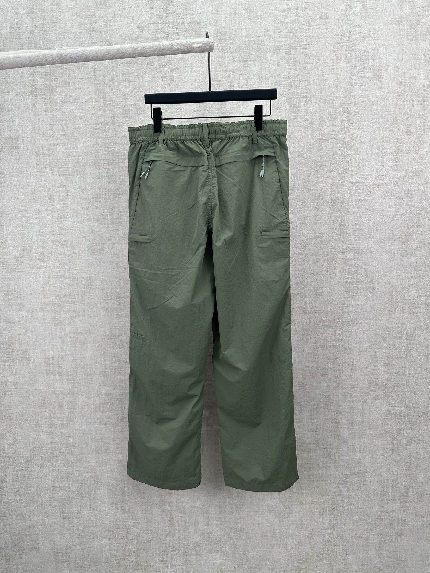 Olive green Louis Vuitton pants, back view with two rear pockets and belt loops