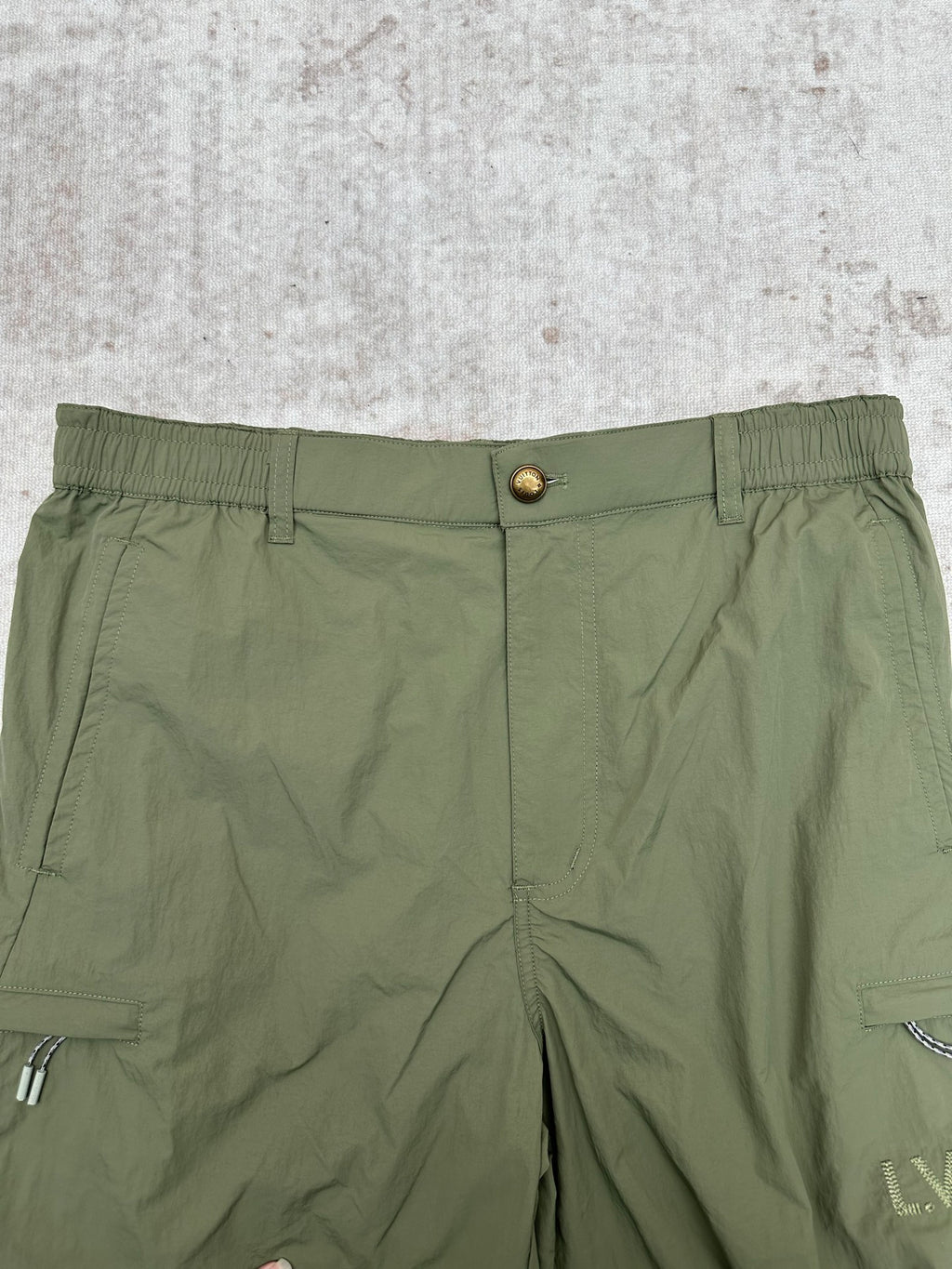 Olive green Louis Vuitton pants waistband with button closure and front pleated seams