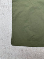 Olive green Louis Vuitton pants fabric close-up with stitched hem