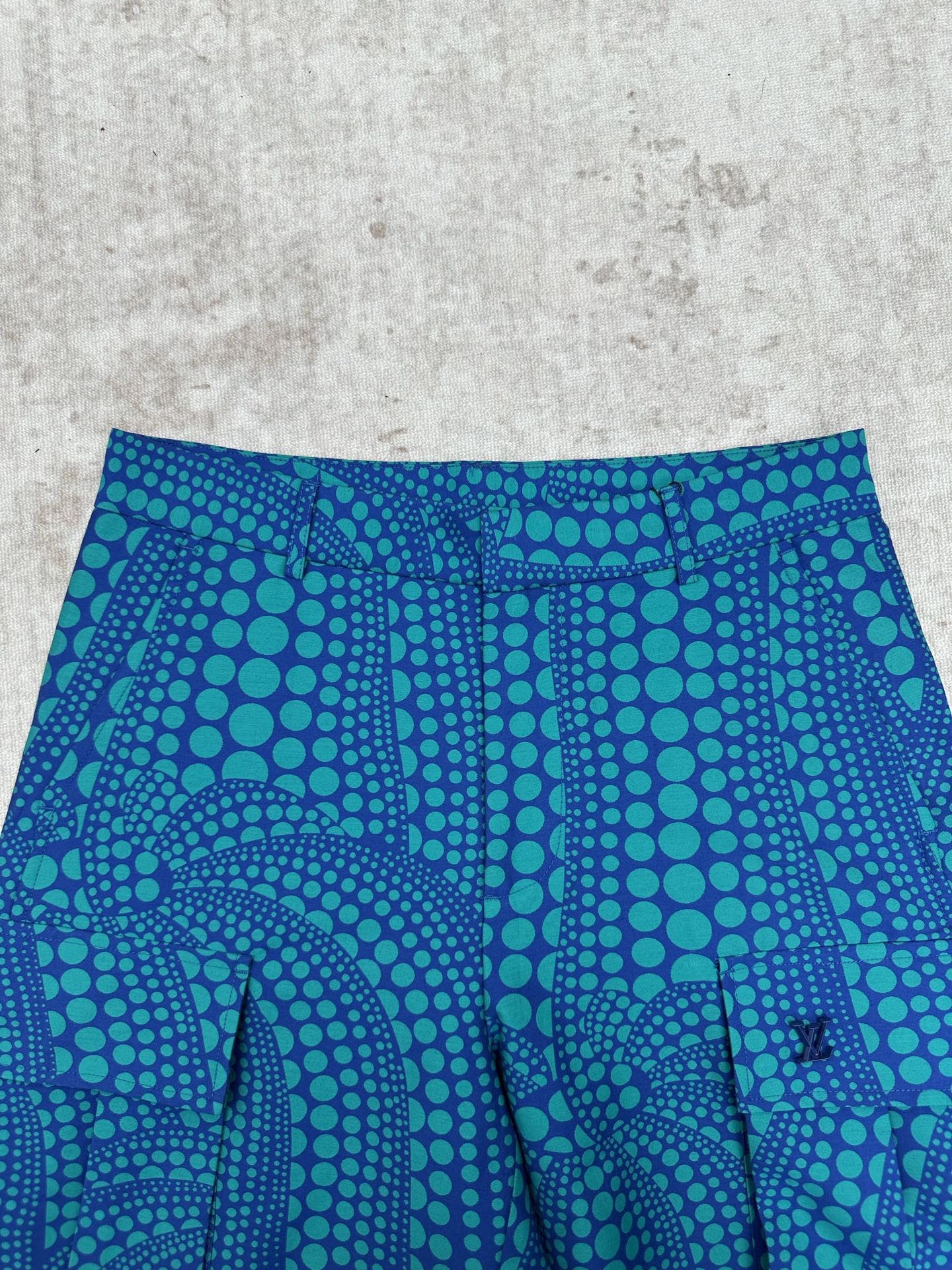 Blue shorts with teal circular pattern and front seam detail