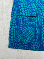 Blue patterned shorts with teal circular motif and patch-style front pockets
