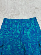Blue shorts with teal circular pattern and pleated front panel