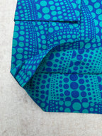 Blue patterned shorts with teal circular print and side seam detail
