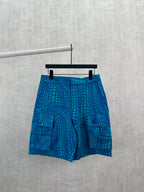 Blue patterned shorts with teal circular motif, relaxed fit and elastic waistband