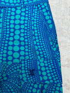 Blue patterned shorts with teal circular print and front crease detail