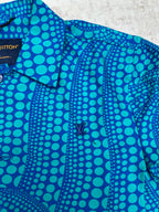 Blue long-sleeve button-up shirt with teal dot pattern and button placket