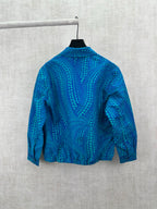 Blue long-sleeve button-up shirt with teal dot pattern, back view