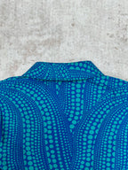 Blue long-sleeve button-up shirt collar with teal dot pattern