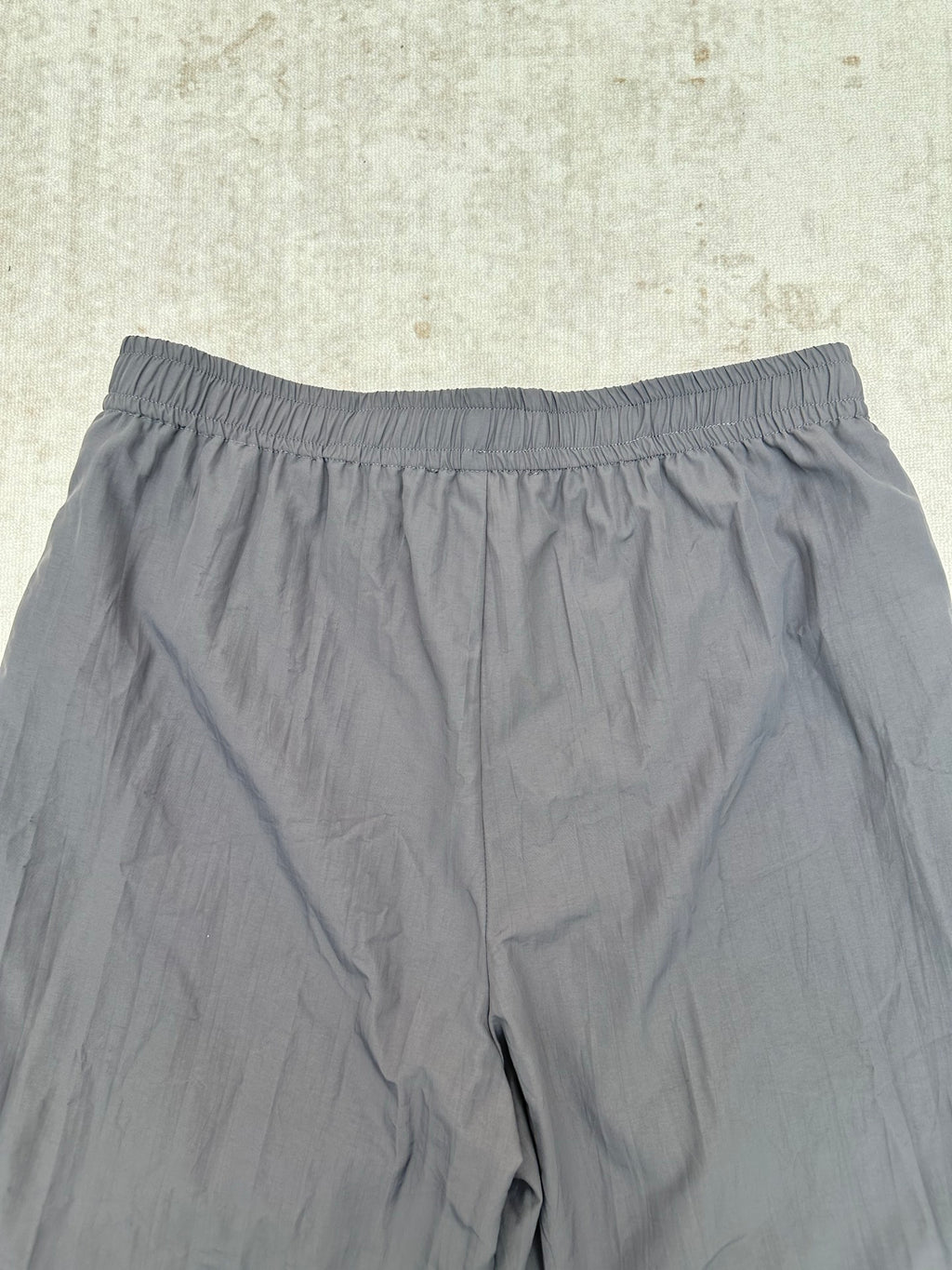 Gray shorts with elastic waistband, close-up view of the front.