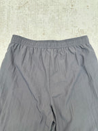 Gray shorts with elastic waistband, close-up view of the front.