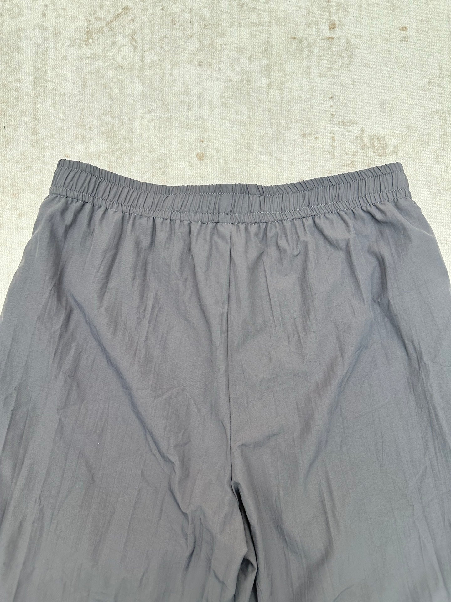 Gray shorts with elastic waistband, close-up view of the front.