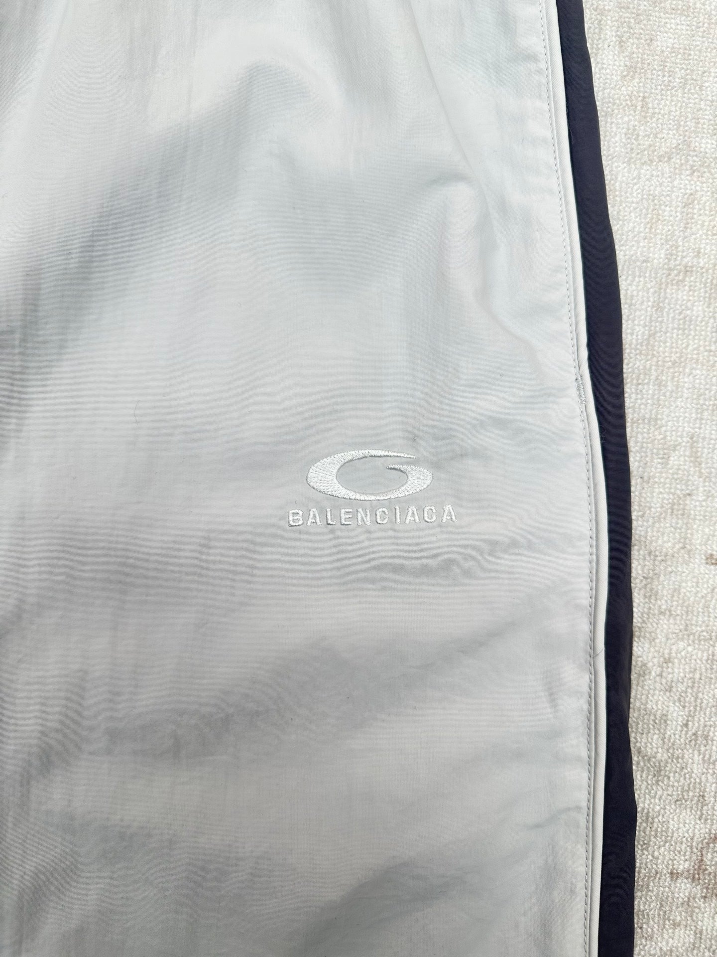 White shorts with BALENCIAGA logo on leg, side seam and zipper fly.