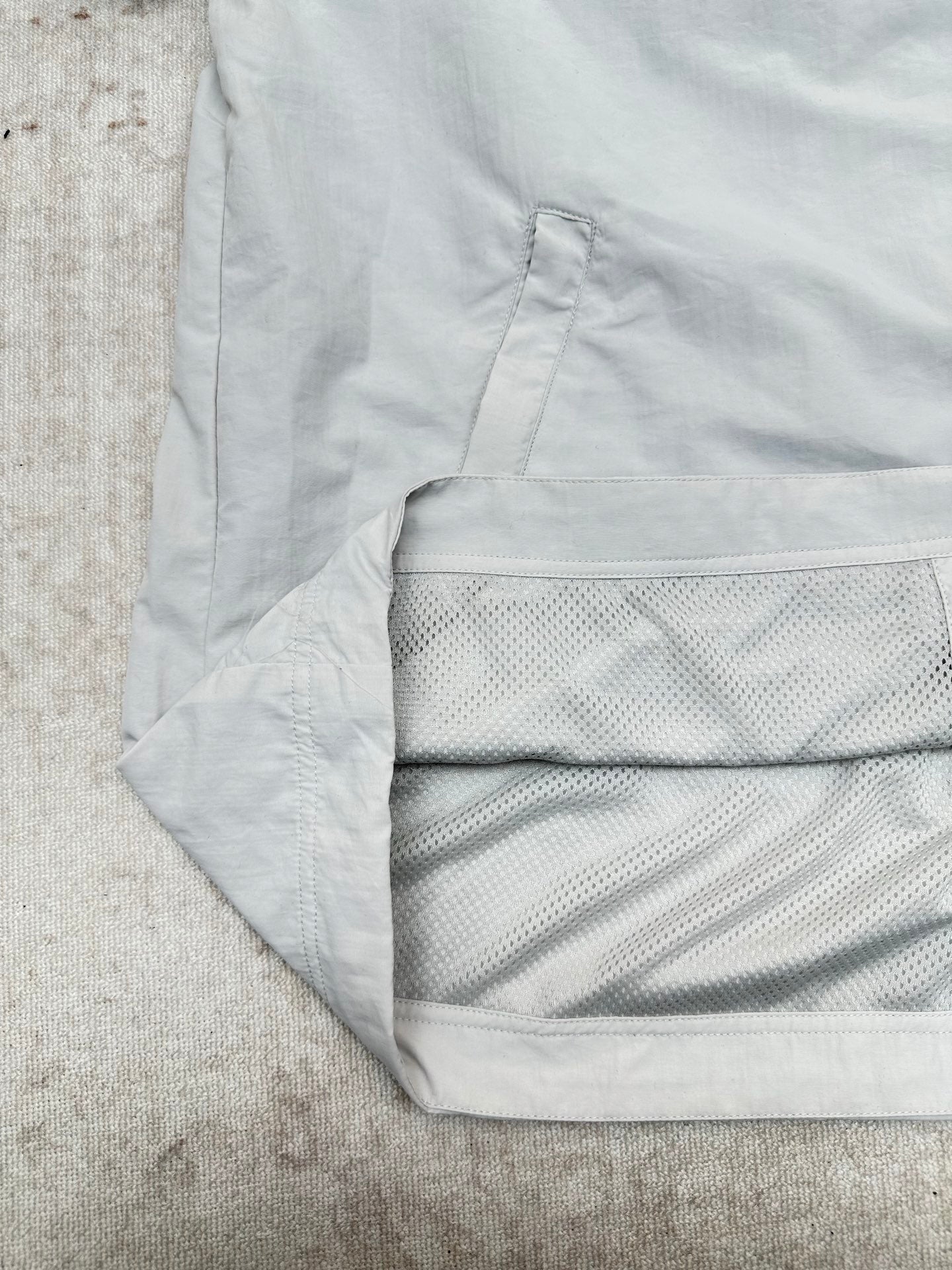 Light blue jacket hem with textured mesh lining panel detail