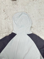 Light blue and navy hooded jacket with high neck, seam detail