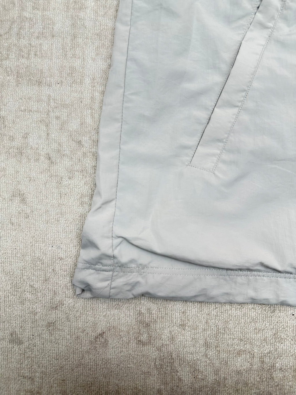 Light blue jacket hem with stitched cuff and panel seams