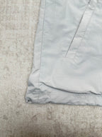 Light blue jacket hem with stitched cuff and panel seams