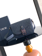 Navy Dior crossbody bag with embossed logo flap and adjustable strap