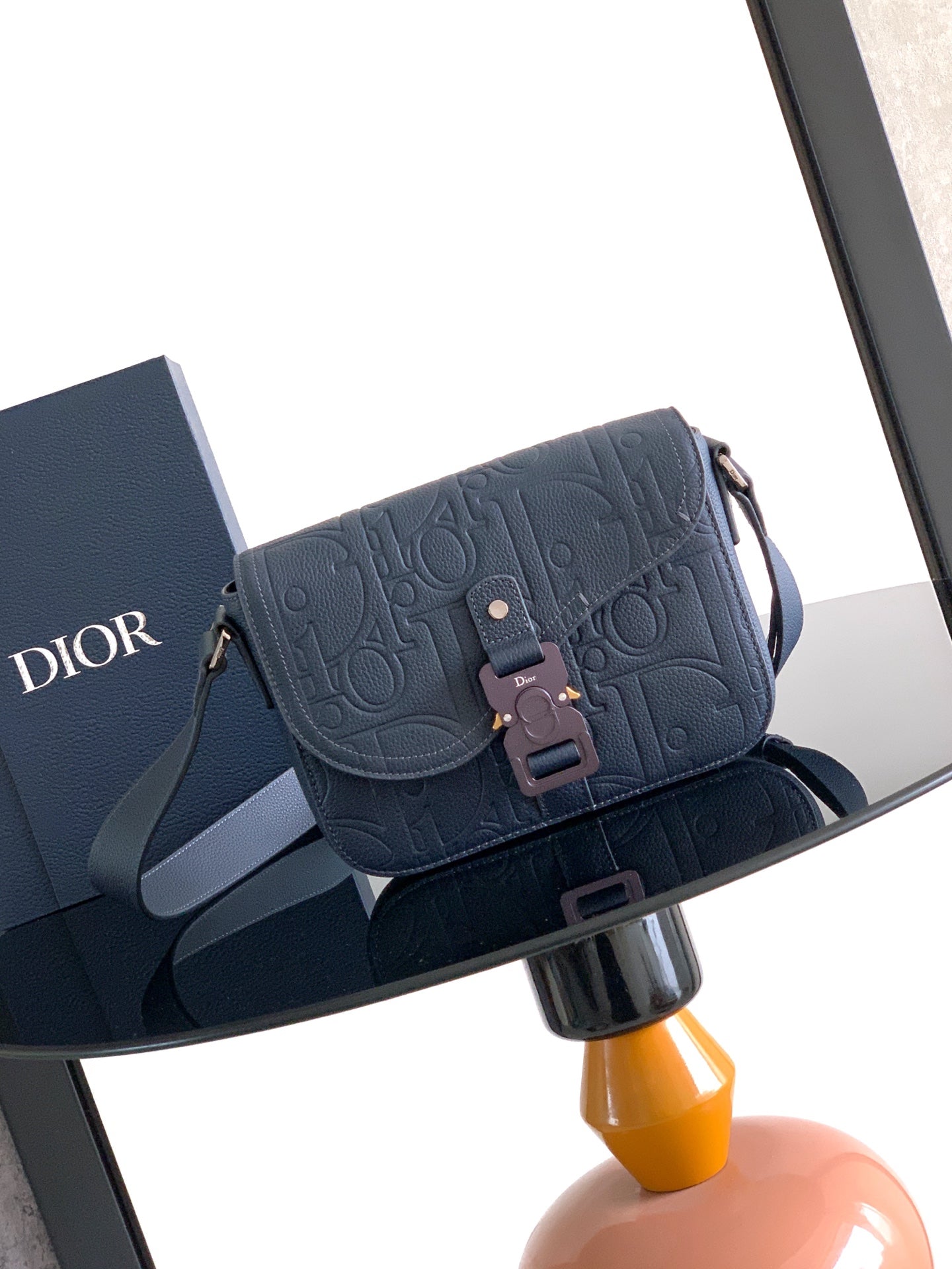 Navy Dior crossbody bag with embossed logo flap and adjustable strap