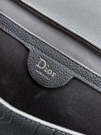 Close-up of navy Dior logo on flap pocket inside the crossbody bag