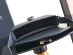 Navy crossbody bag open view with dark interior and front clasp detail