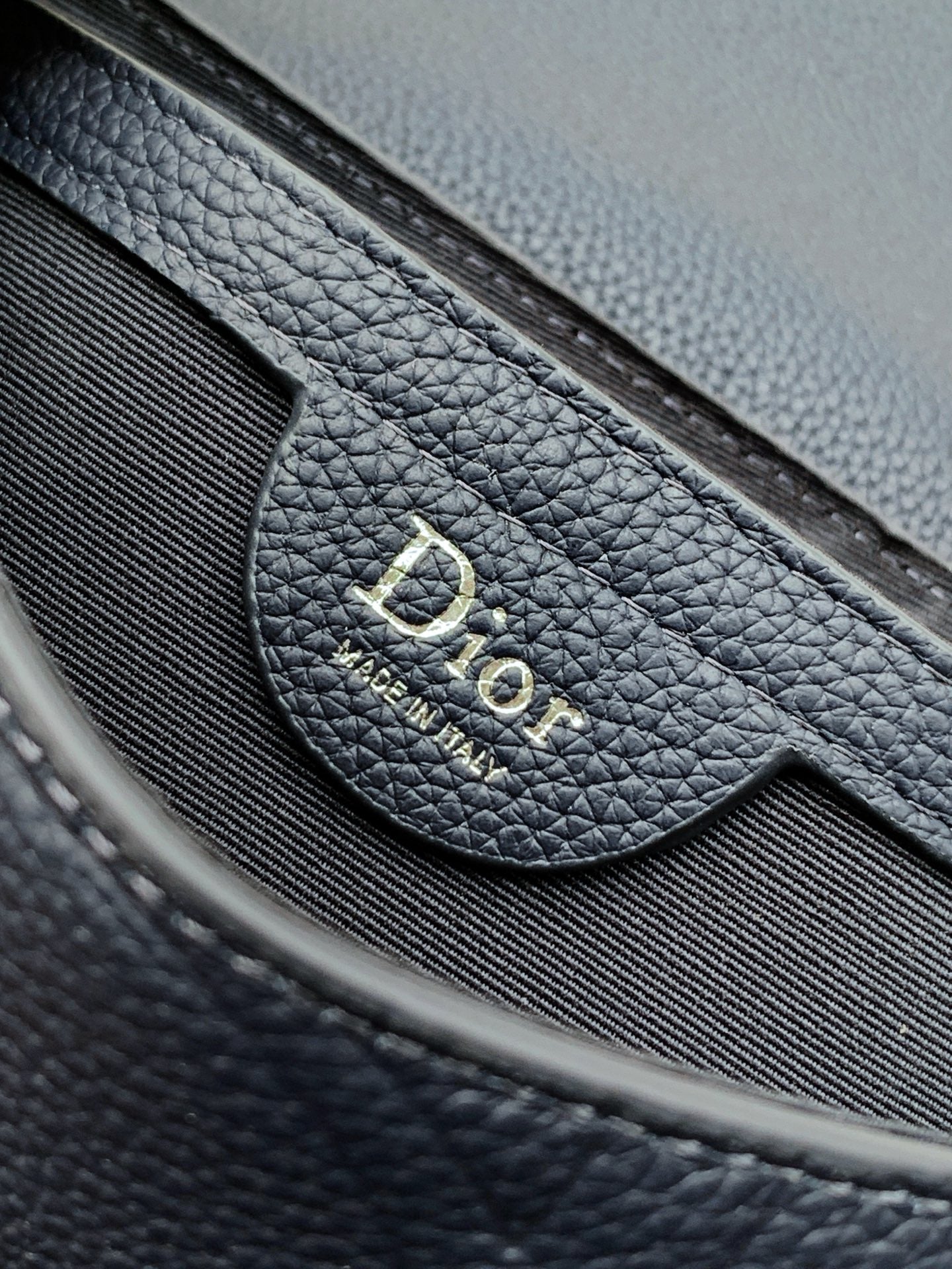 Navy blue Dior bag interior patch with embossed Dior logo