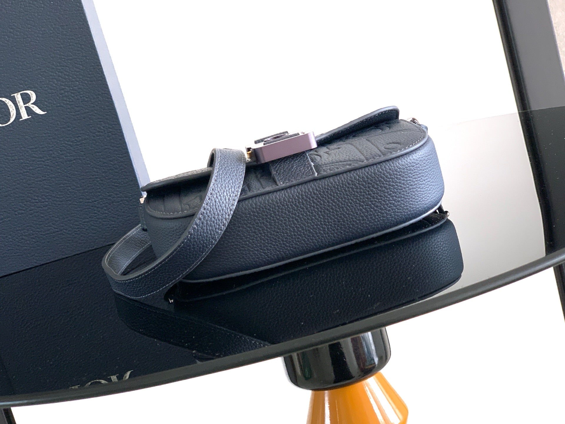 Navy blue Dior crossbody bag with adjustable strap and top clasp