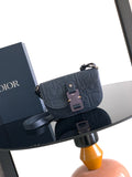 Navy blue Dior crossbody bag with embossed logo and front flap closure