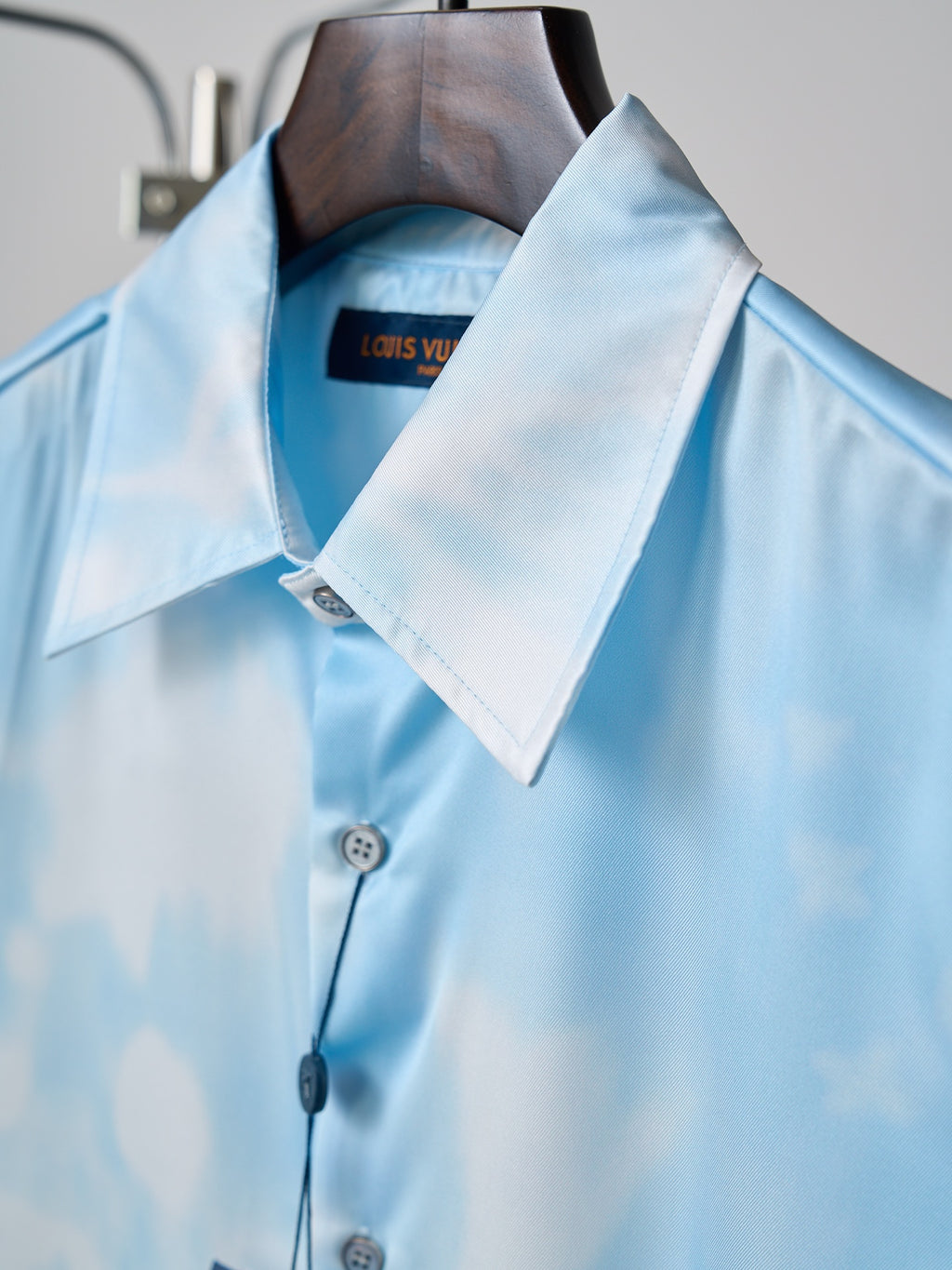 Light blue button-up shirt collar with Louis Vuitton label on the inside neckline