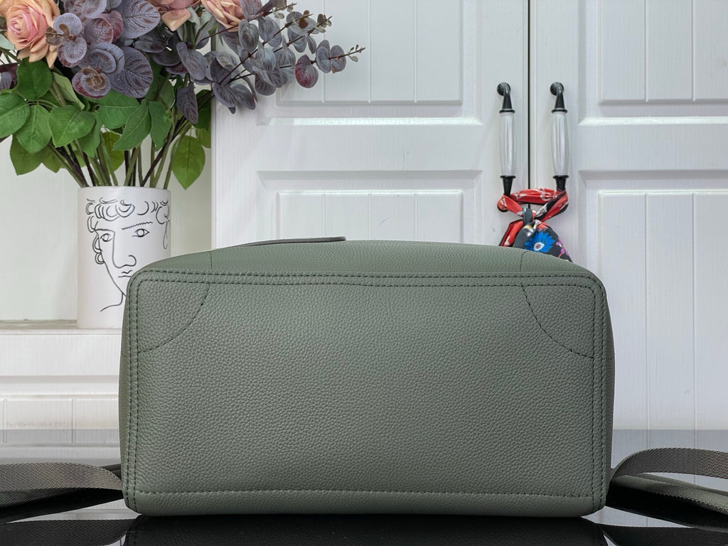 Louis Vuitton leather backpack bottom/front view with rounded flap edge, sage green.