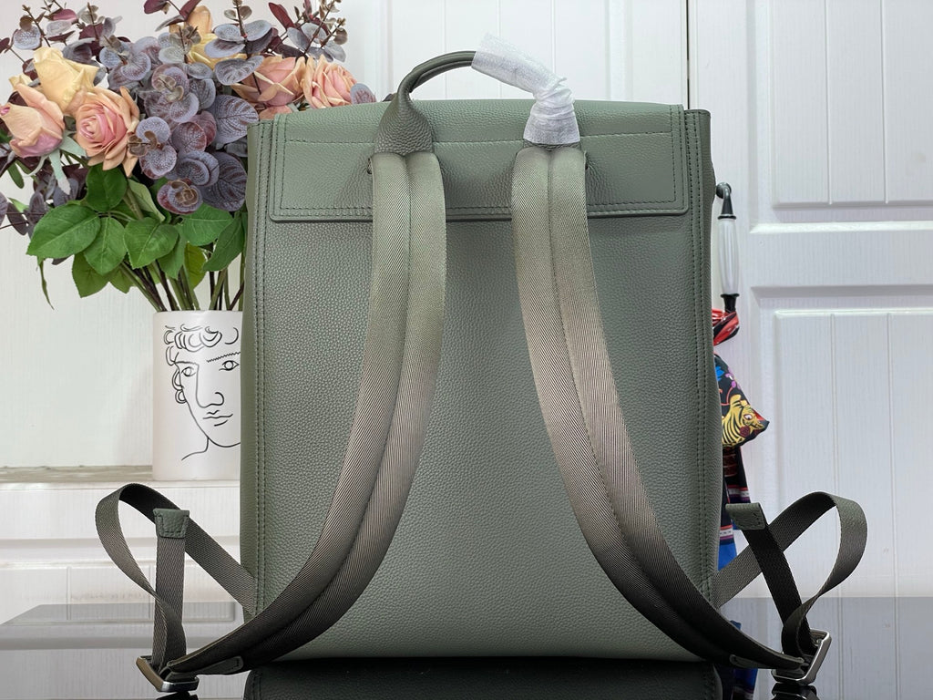 Louis Vuitton leather backpack back view with top handle and adjustable straps, sage green.