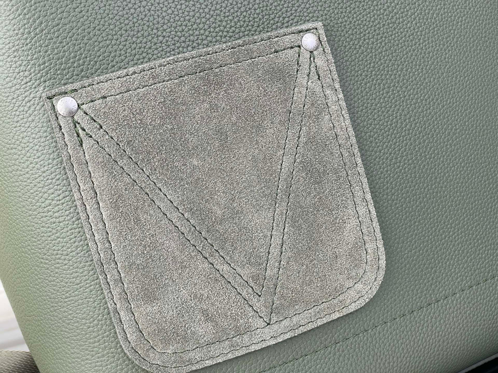 Louis Vuitton leather backpack front pocket panel with stitched trim, sage green.