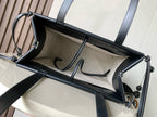 Open cream-and-dark tote bag showing striped lining and interior logo