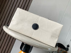 Cream canvas clutch pouch with dark snap button and round logo patch
