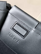 Leather logo label and stitching detail on a Loewe tote bag