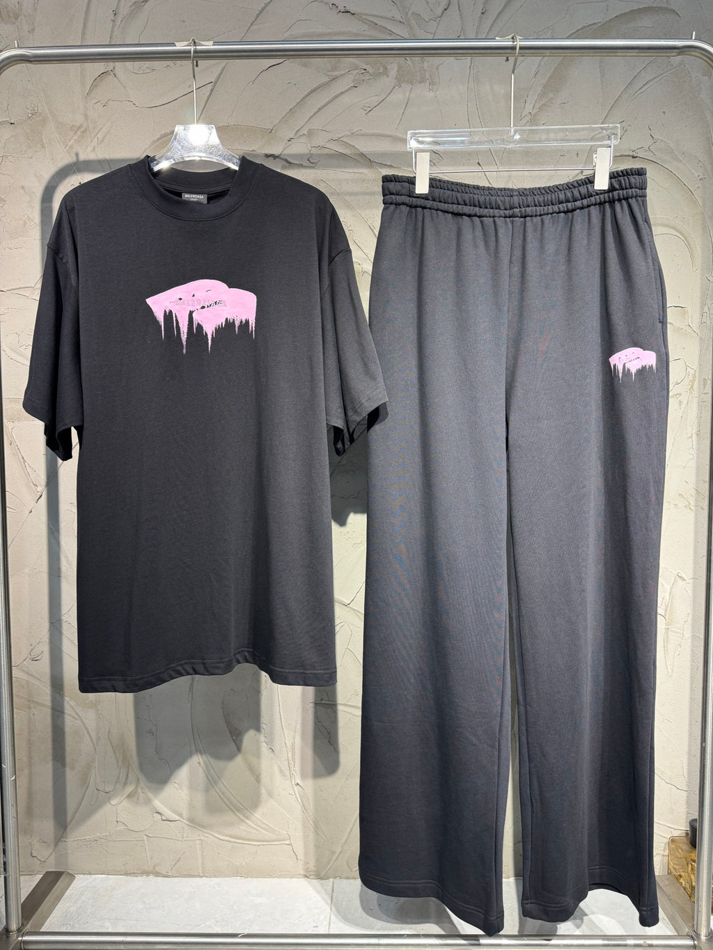 Dark gray wide-leg sweatpants with pink skyline graphic on leg