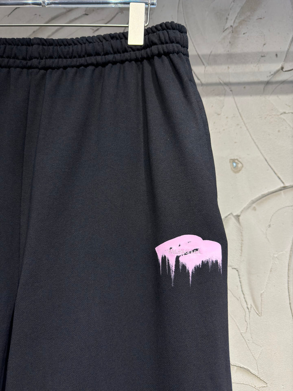 Dark pants with pink mountain graphic print on the leg