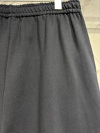 Dark pants with elastic waistband and relaxed straight leg opening